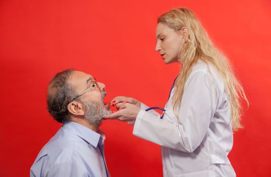 Adult male with female doctor, medical examination of sore throat.