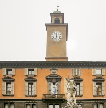 statue of river Crostolo with Palazzo del Monte and the civic tower in the background in Reggio Emilia, Italy