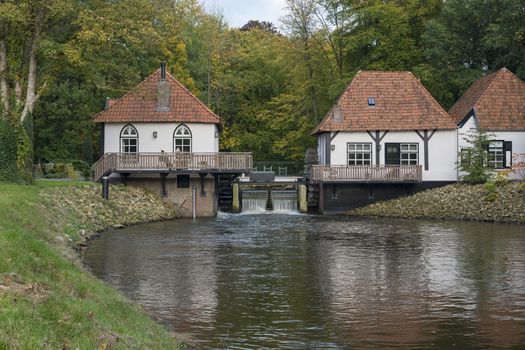 The recently restored historic water mill called The Olliemölle or Den Helder in the stream of the river the Boven-Slinge in Winterswijk in Hamlet the Achterhoek in the Netherlands. The water mill is a national monument and the restoration is completed in 2016.
