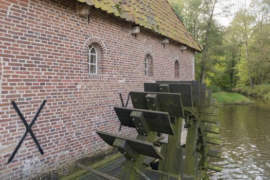 The restored historic water mill called Berenschot in the stream of the river the Boven-Slinge in Winterswijk in Hamlet the Achterhoek in the Netherlands.
