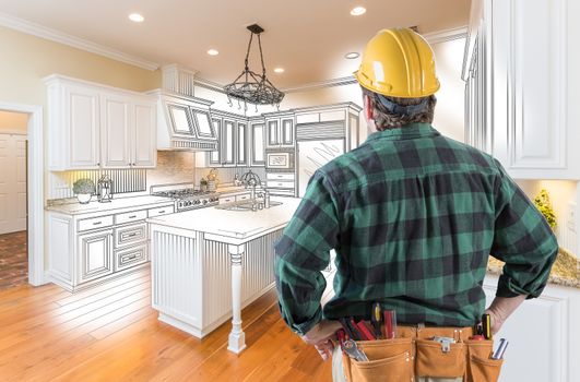 Male Contractor with Hard Hat and Tool Belt Looking At Custom Kitchen Drawing Photo Combination On White.