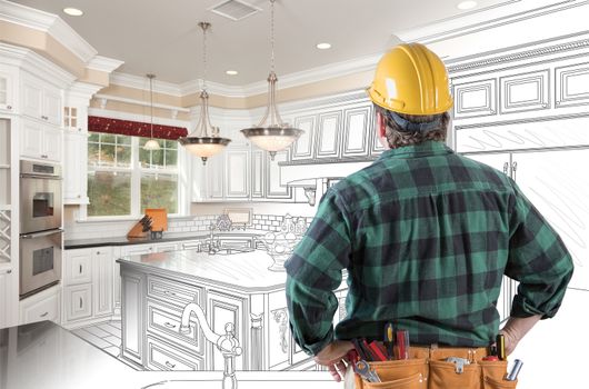 Male Contractor with Hard Hat and Tool Belt Looking At Custom Kitchen Drawing Photo Combination On White.