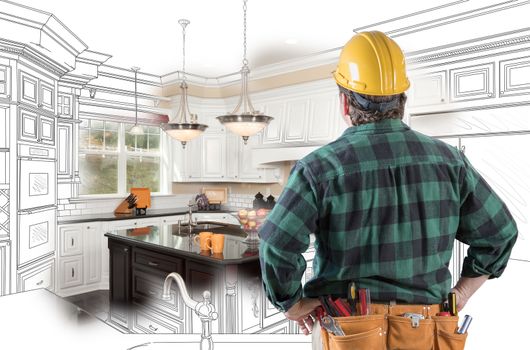 Male Contractor with Hard Hat and Tool Belt Looking At Custom Kitchen Drawing Photo Combination On White.