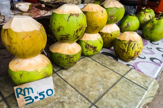 Fresh coconuts being sold at roadside stall in Borneo