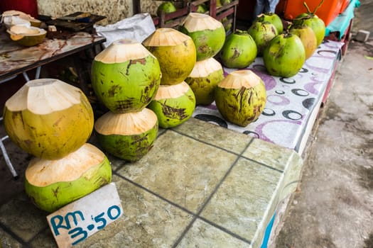 Fresh coconuts being sold at roadside stall in Borneo