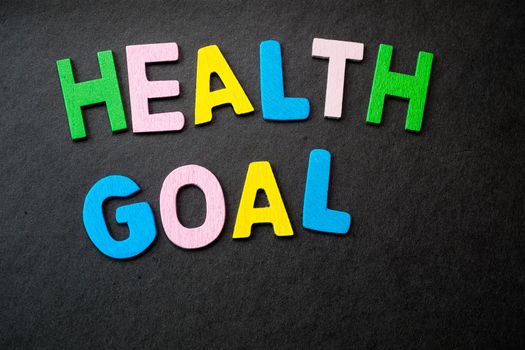 Colorful wooden letters forming the phrase "health goal"