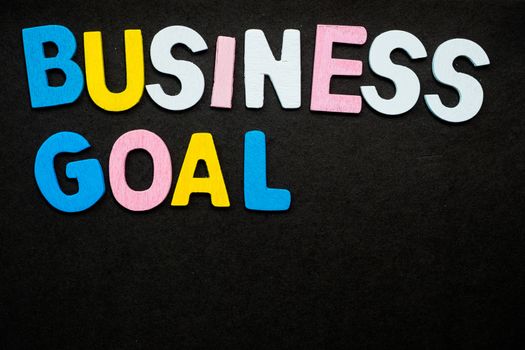 Colorful wooden letters forming the phrase "business goal"