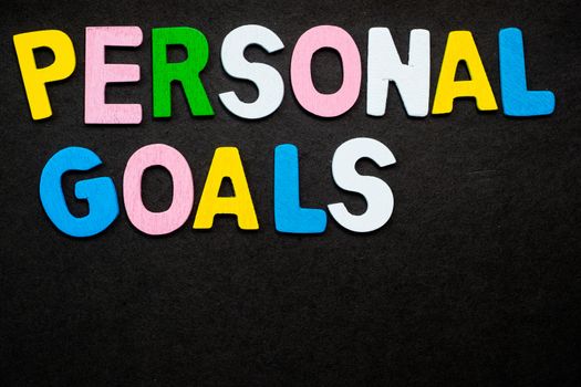 Colorful wooden letters forming the phrase "personal goals"