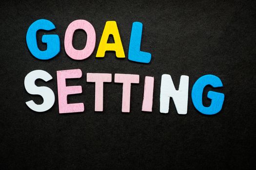 Colorful wooden letters forming the phrase "goal setting"