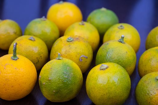 Fresh limes arranged randomly on a table top