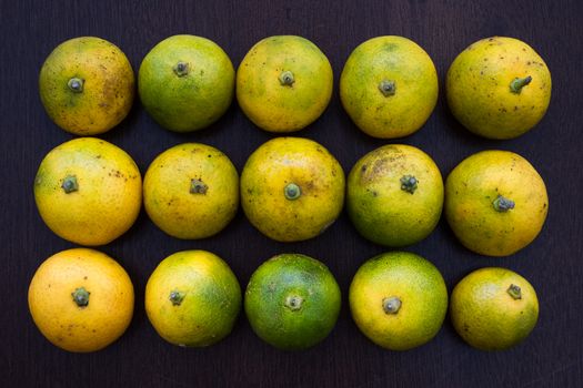 Overhead view of fresh limes arranged on a table top