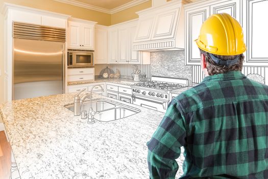 Male Contractor with Hard Hat and Tool Belt Looking At Custom Kitchen Drawing Photo Combination On White.