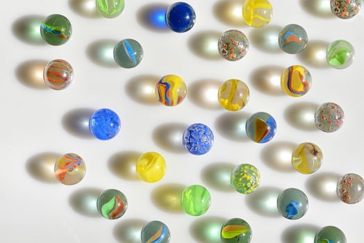 Colorfull glass marbles on white table