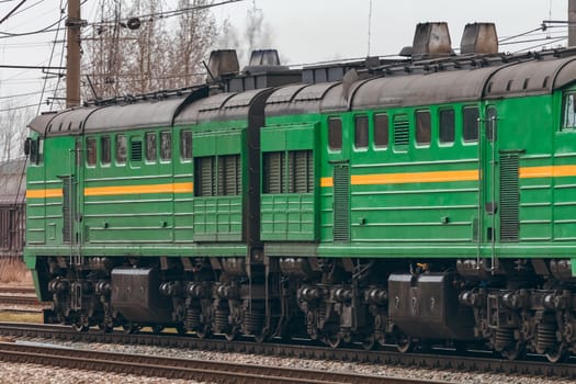 Green diesel cargo locomotive. Freight train in action