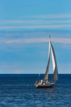 Blue sailboat in travel by Europe. Sea journey