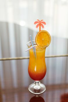 Tequila Sunrise cocktail on the window background