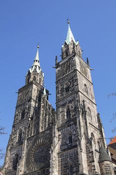 Saint Lawrence cathedral (St. Lorenz) over clear blue sky, medieval gothic church in Nuremberg, Germany, low angle view