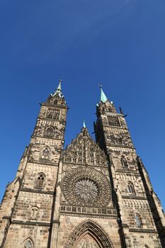 Saint Lawrence cathedral (St. Lorenz) over clear blue sky, medieval gothic church in Nuremberg, Germany, low angle front view