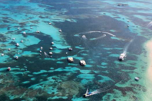 Aerial view of the reef in the ocean with boats. Dominican Republic