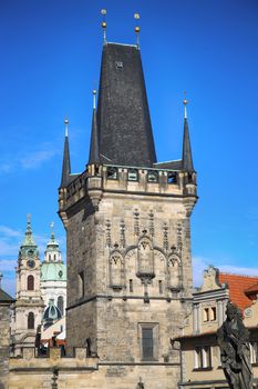 View of the Lesser Bridge Tower and Cathedral of Saint Nicolas from the Charles Bridge (Karluv Most) in Prague, Czech Republic 