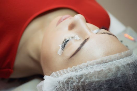Eyelash Extension Procedure. Woman Eye with Long Eyelashes. Lashes, close up, macro, selective focus