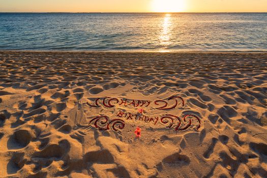 Handwritten on the sand "Happy birthday",beautiful sand beach at sunset.