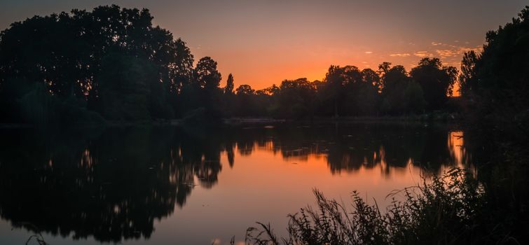 Vincennes park and lake close to Paris at dusk