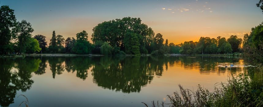 Vincennes park and lake with swans at dusk