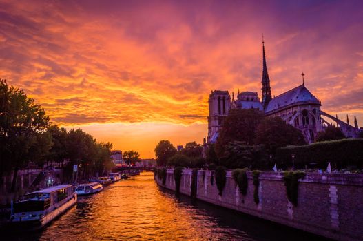 Stunning pink sunset over Paris and Notre dame de Paris cathedral