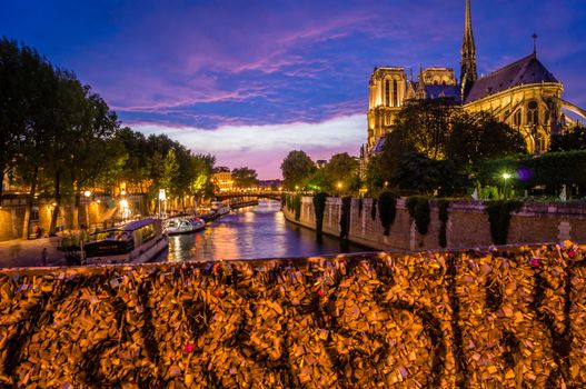 Love locks on a Paris bridge at night