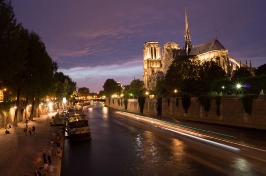 Peniche boats passing by Notre Dame de Paris cathedral