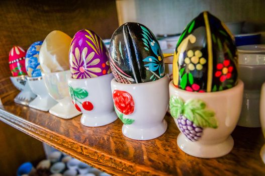 French porcelain painted eggcups with painted eggs on top