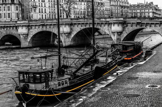 Black and white old boats on a Paris wharf