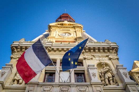 French and european flag on building of the city hall in the 12th arrondissement of Paris