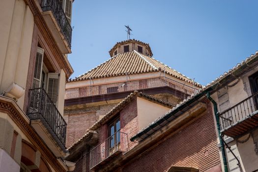 Sloping rooftop of a church in Malaga, Spain, Europe on a bright summer day with clear blue sky