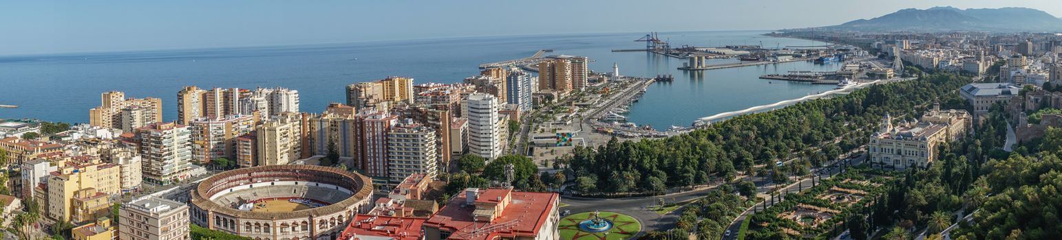 Panorama City skyline and harbour, sea port, bullring of Malaga overlooking the sea ocean in Malaga, Spain, Europe  on a summer day with blue sky