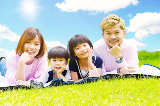 Outdoor portrait of a happy asian family