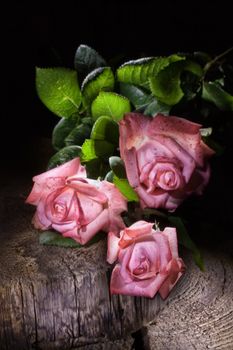 Bouqet of roses on an old wood