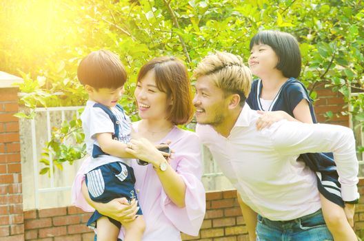 Outdoor portrait of a happy asian family