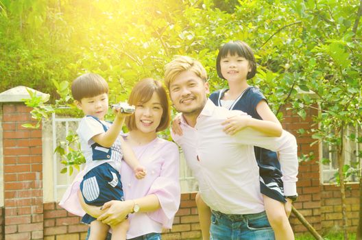 Outdoor portrait of a happy asian family