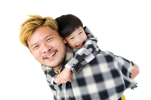 Asian father piggyback his son in the studio.