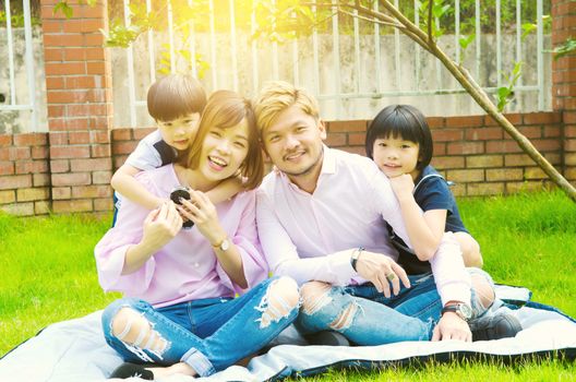 Outdoor portrait of a happy asian family