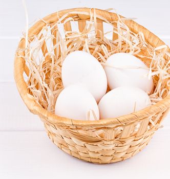 Eggs in basket on the white background