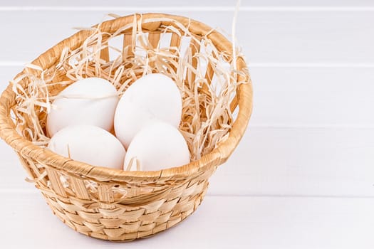 Eggs in basket on the white background