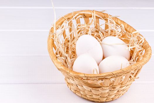Eggs in basket on the white background