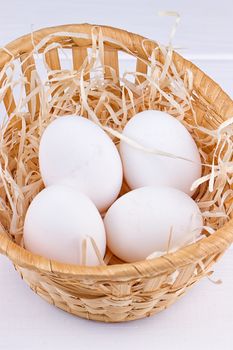 Eggs in basket on the white background