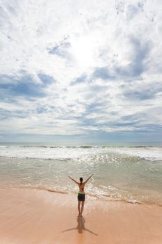 Asia - Sri Lanka - Ahungalla - A woman enjoying the sunshine at the beach