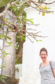 Maduganga Lake, Balapitiya, Sri Lanka - A young woman smiling lovely because she saw an Indian Giant Squirrel