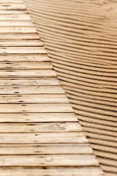 close up of wood in a beach with sand as background