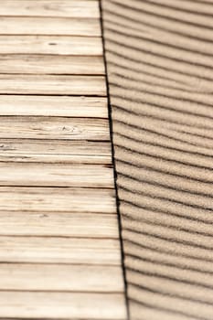 close up of wood in a beach with sand as background